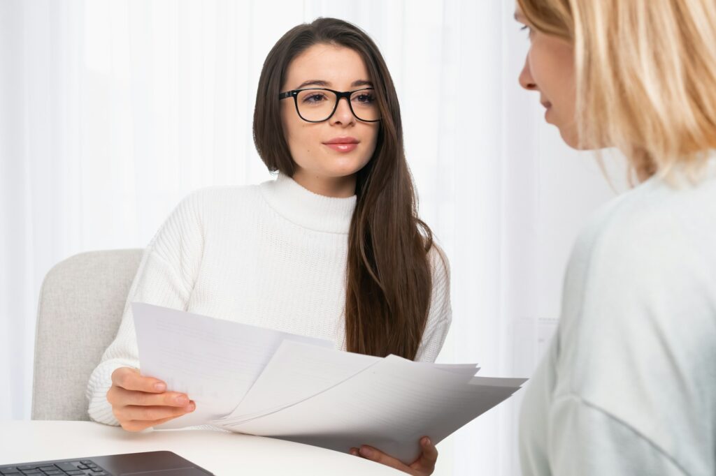 Insurance agent consulting client and shows documents