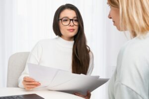 Insurance agent consulting client and shows documents