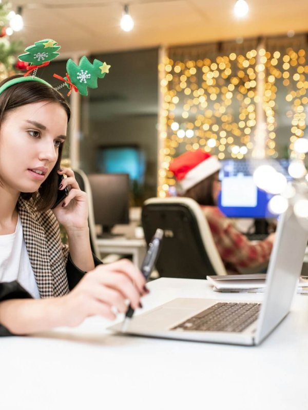 Young contemporary businesswoman with mobile phone organizing work in office