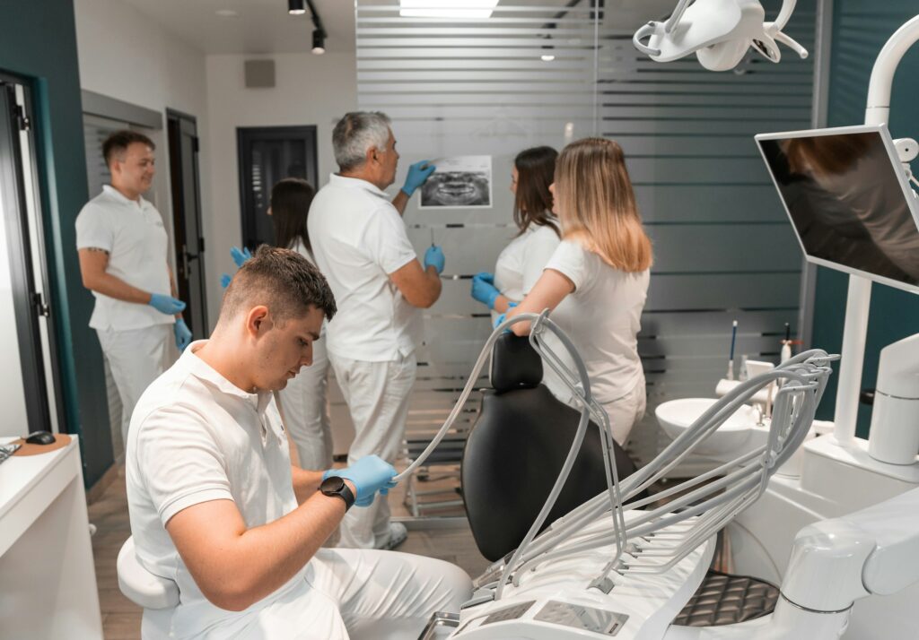 Dentists work in dental office. Doctors discuss treatment plan and consult and consult with